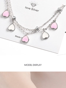 Detail of pink gradient flower charms on double-layer silver bracelet for women