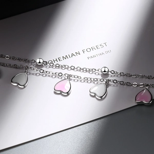 Double-layer silver bracelet featuring pink and white gradient heart-shaped pendants