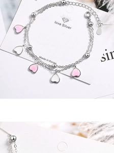 Detail of pink gradient enamel heart charms on a double-layer S925 silver bracelet