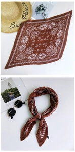 Detail of red pleated paisley silk scarf featuring vintage patterns and soft fabric texture