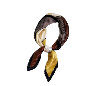 Pleated square silk scarf in color-block yellow and brown, displayed on white background