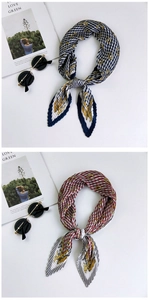 Detailed view of pleated silk scarves featuring horse prints in navy and red patterns