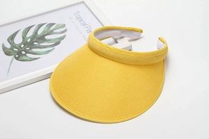 Detailed macro view of breathable yellow mesh fabric on a stylish sun visor hat