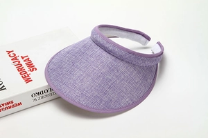 Detail of purple wide brim sun hat with breathable texture and adjustable velcro strap
