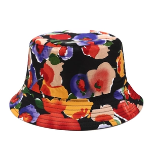 Close-up of a black bucket hat featuring vibrant floral print and reinforced brim stitching