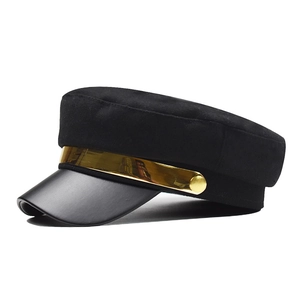 Black baker boy hat with matte finish, leather visor, and wide gold mirror metal band
