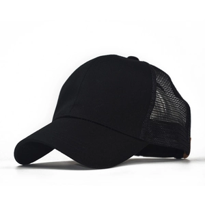 Detail of the breathable mesh back and cotton twill brim on a black ponytail baseball cap