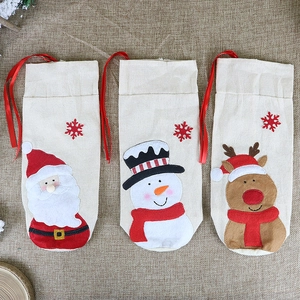 Three-piece linen Christmas wine bottle bags with Santa, snowman and reindeer designs
