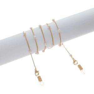 Detail of gold chain glasses strap with white pearls wrapped on white cylinder