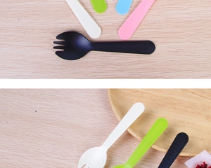 Close-up of colorful mini disposable plastic sporks on a bright wooden tabletop