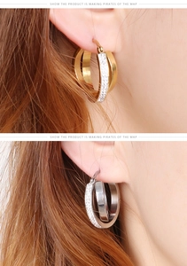 Close-up of gold and silver hoop earrings with shimmering crystals on models