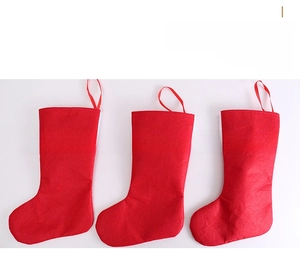 Close-up of three red felt Christmas stockings with hanging loops for holiday decorations