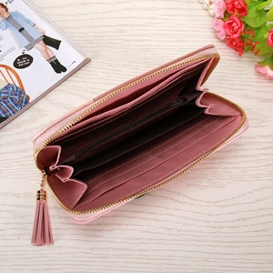 Detail view of pink long wallet interior with multiple card slots and tassel zipper pull