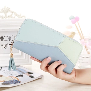 Macro detail of geometric color block wallet with leather texture and tassel zipper