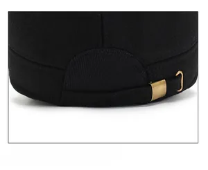 Close-up of adjustable strap with bronze metal buckle on wool flat cap for men