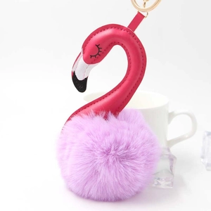 Detail of pink leather flamingo keychain with a soft purple faux fur pompom ball