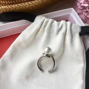 Elegant silver twisted open ring with natural freshwater pearl on white canvas gift bag