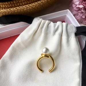 Minimalist gold knot open ring with natural freshwater pearl on elegant gift packaging