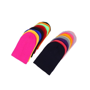 Classic knitted winter beanie hats available in various bright colors on white background