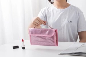 Detailed view of pink sequin cosmetic bag with handle and waterproof finish