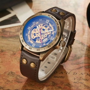 Macro detail of bronze skeleton watch with rivet leather strap on vintage map background