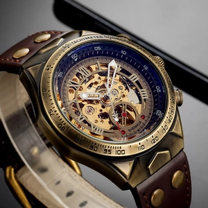 Macro view of retro bronze skeleton watch showing inner golden gear mechanism and Roman numerals