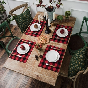 Classic red and black buffalo plaid placemats set of four on a rustic wooden dining table