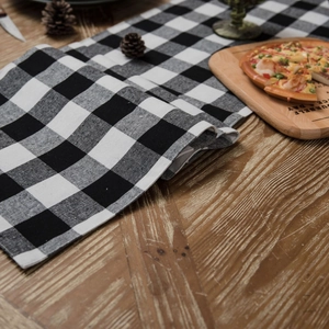 Classic black and white checkered table runner on a vintage wooden dining table decor