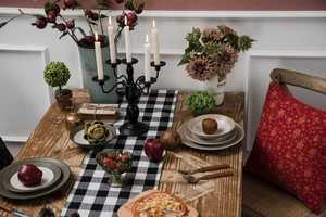 Close-up of black and white checkered table runner on a wooden dining table