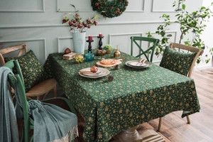 Deep green Christmas tablecloth set featuring golden snowflakes and holiday prints