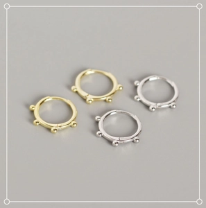 Close-up of minimalist S925 sterling silver hoop earrings with five decorative beads