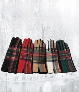 Close-up of five patterns of British plaid winter woolen gloves for outdoor warmth