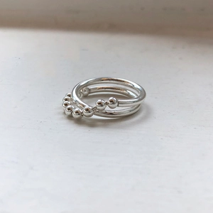 Macro shot of 925 sterling silver beaded rings with polished finish in modern minimalist style