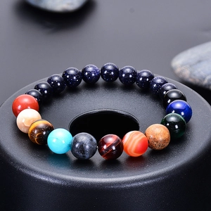 Macro shot of solar system bracelet with blue goldstone and natural tiger eye stones