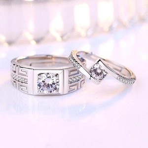 Matching silver couple rings with geometric patterns and sparkling square diamonds