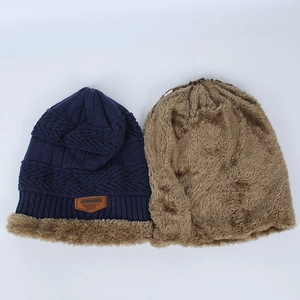Winter knitted beanie in navy blue with thick warm fleece lining and leather label