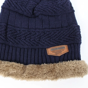 Winter knitted beanie in navy blue with warm plush lining and stylish leather patch