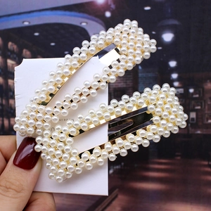 Set of two gold-finish rectangle hair clips with pearl beads on display card