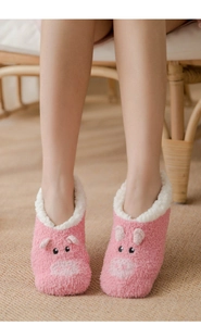 Detail of pink coral fleece thermal socks featuring a 3D pig design and soft fuzzy lining