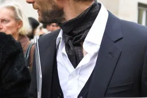 Detail of dark grey geometric jacquard ascot cravat paired with a white shirt