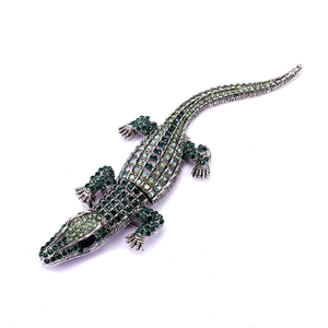 Silver crocodile brooch with green rhinestones and crystals in a realistic design