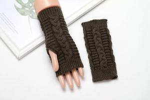 Detail of dark brown cable knit fingerless gloves showing texture and knit pattern