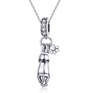Polished silver cat pendant with small paw charm on necklace shown with elegant reflection