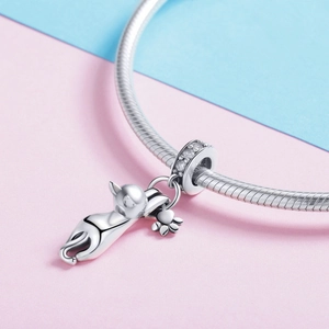 Silver plated cat charm on a Pandora style bracelet with floral details on soft background