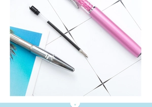 Metal crystal ballpoint pen detail view showing refill, barrel structure and fine tip.