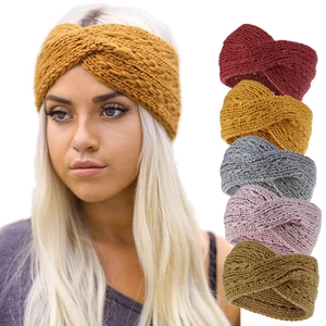 Detail of multi-colored chunky knit twisted headbands for women in various winter colors