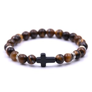 Stretch tiger eye stone bead bracelet with black cross charm and silver spacers on white base