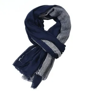 Detail of navy blue and grey woven scarf showing fringe edges and fabric texture