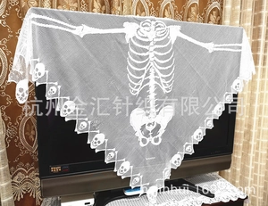 Macro detail of white lace crochet skeleton shawl with skull patterns for Halloween