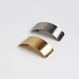 Detailed macro view showing brushed metal texture on gold and silver hair clips